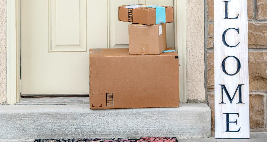 Deliveries on the front porch of a house with a welcome sign in Augusta